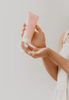 Model squeezing hair cream onto hand