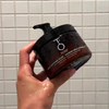 Hand holding TO112 Hair Mask in Shower