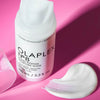 white bottle of hair mask on bright pink background
