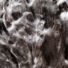 Close up of brown hair in shampoo suds